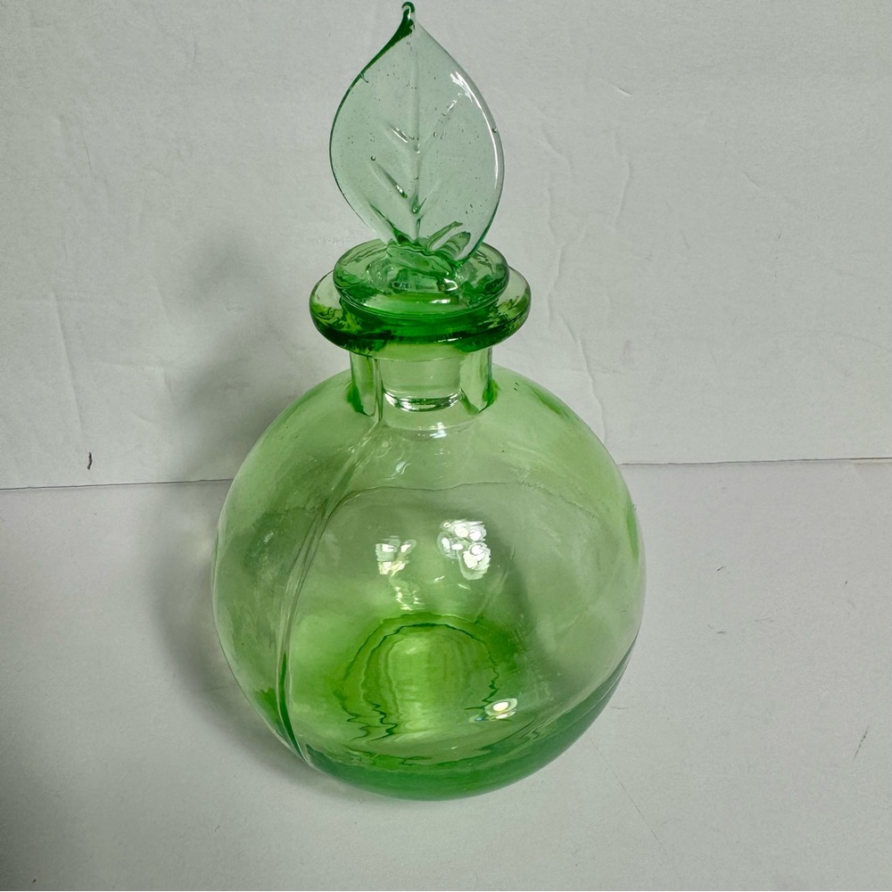 Gardeners Eden Glass Perfume green glass Bottle with green leaf top.